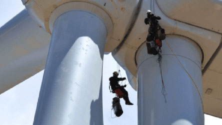 wind turbine technicians hanging below top